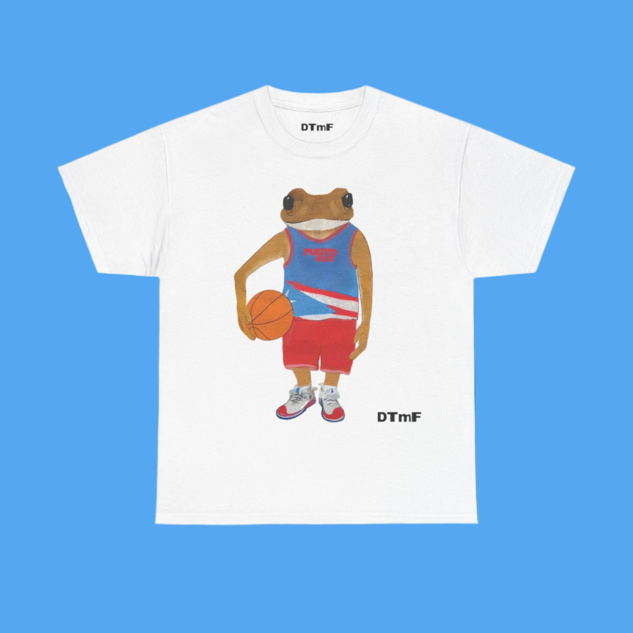 White t-shirt with a frog playing basketball graphic on a blue background