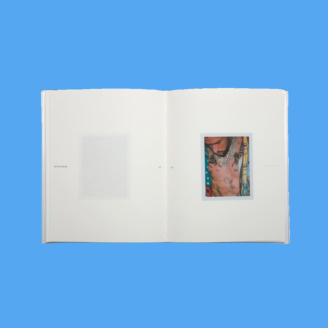 Open book with a small inset image of a tattoo on a white background