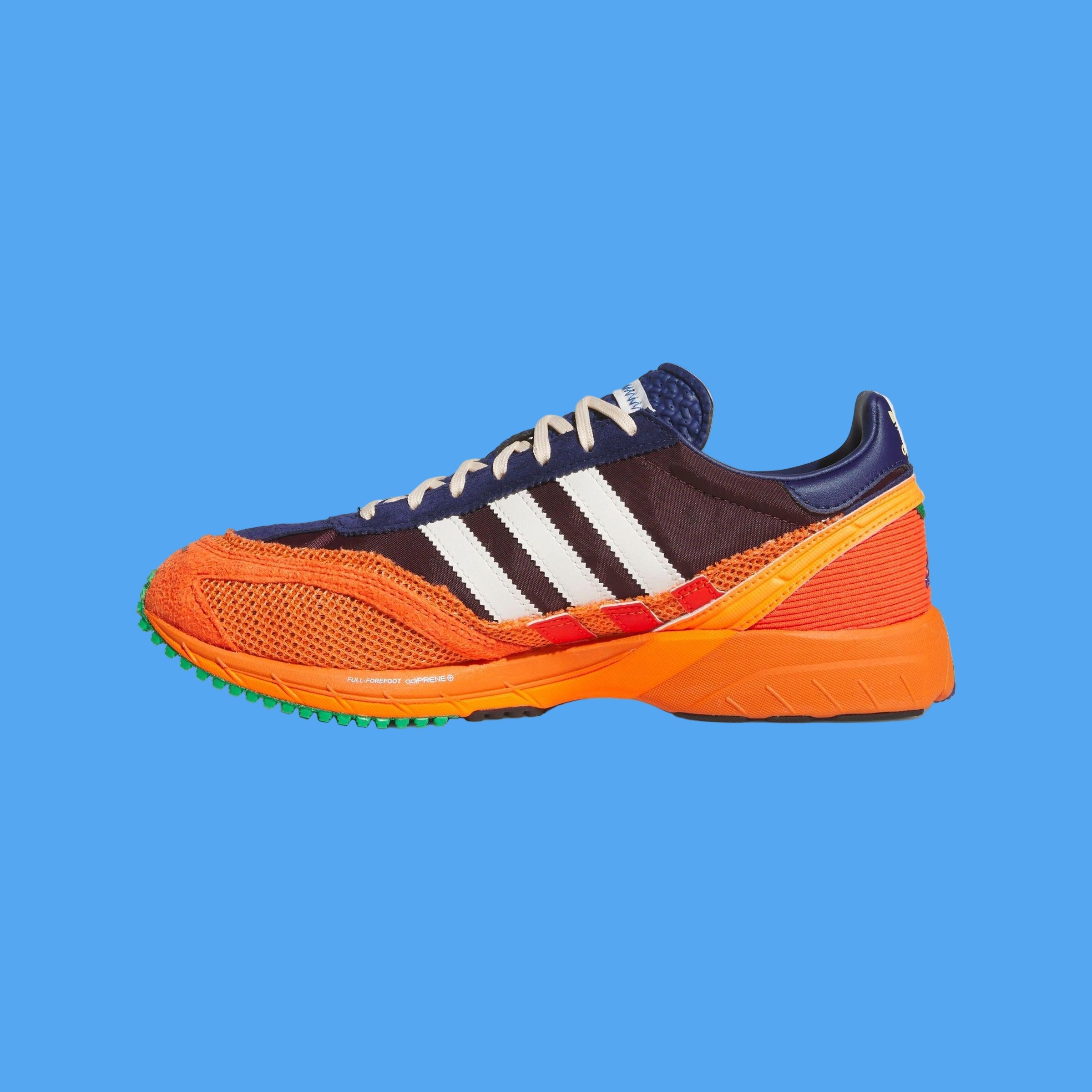 Adidas sneaker with orange and brown design on a light gray background